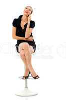 smart woman sitting on a stool holding a cellphone on white back