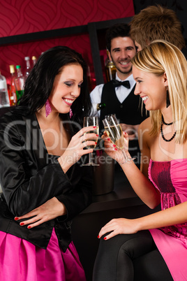 Happy girl friends with drinks enjoying party