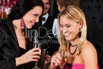 Happy girl friends with drinks enjoying party
