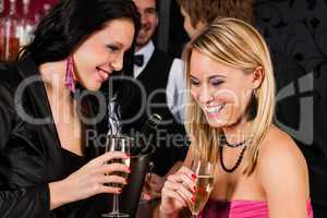 Happy girl friends with drinks enjoying party
