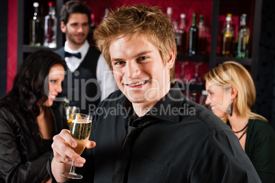 Young man at the bar drink champagne
