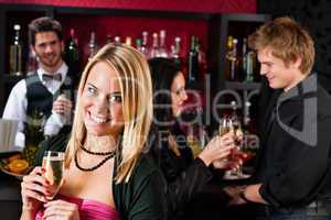 Attractive girl at bar smiling with friends