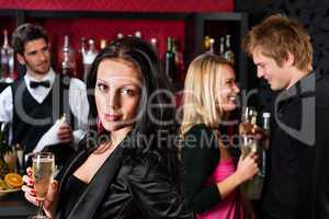 Attractive girl smiling with friends at bar
