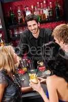 Barman chatting with friends drinking at bar