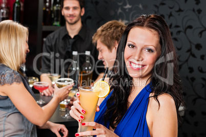 Party girl smiling with friends at bar