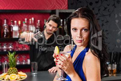 Glamour woman at bar holding cocktail