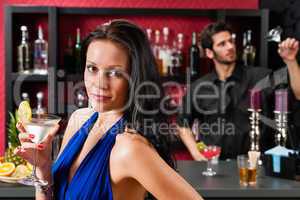 Glamour woman at bar holding cocktail