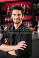 Barman wear black standing at cocktail bar