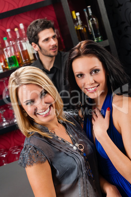 Girl friends at the bar hugging together