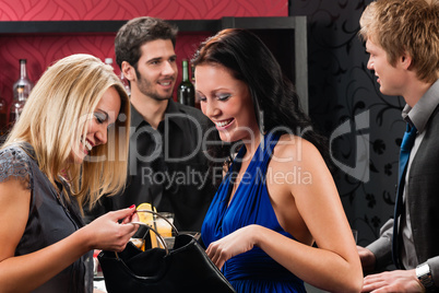 Girl friends at the bar chatting together