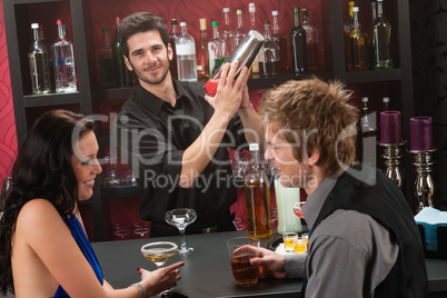 Bartender shaking cocktail friends having drink
