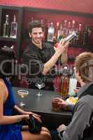 Bartender shaking cocktail friends having drink