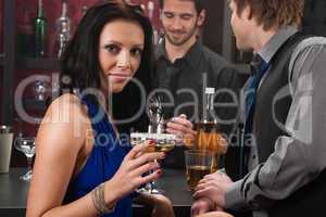 Attractive woman sitting at the bar drink