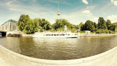Motion Speed Boats on the Berlin Spree River in 1080p FullHD Timelapse with Berlin Television Tower (Fernsehturm) in backround  and dynamic blue clouds, famous landmark in Berlin, Germany , Europe