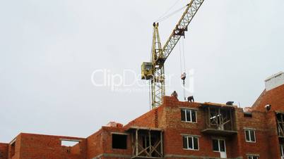 Workers Lay Bricks Behind Crane Timelapse