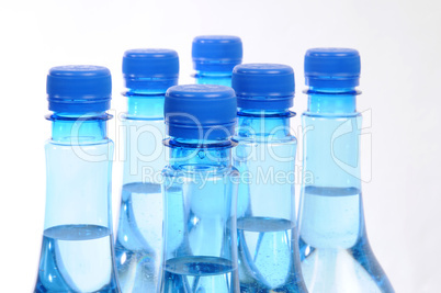 close up of gas water bottles on a white background