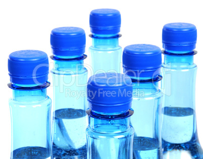 close up of gas water bottles on a white background