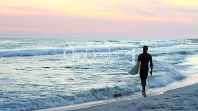 Surfer Walking At Sunset