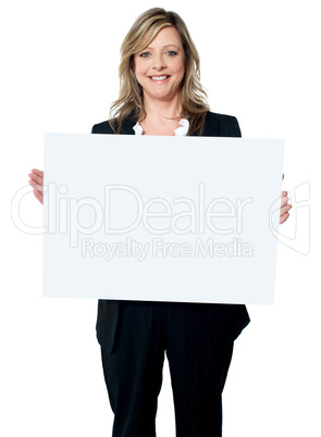 Smiling woman holding a blank billboard