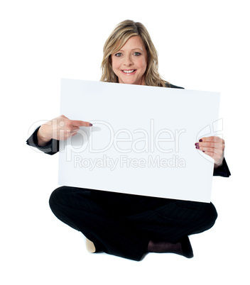 Professional female executive pointing towards billboard