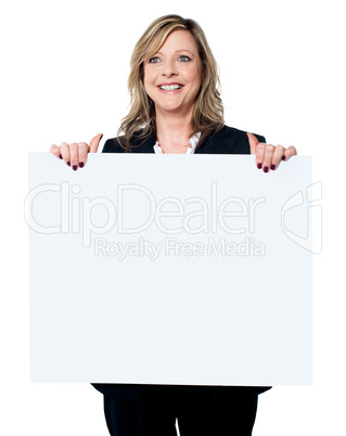 Female business professional holding blank billboard