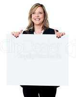 Female business professional holding blank billboard
