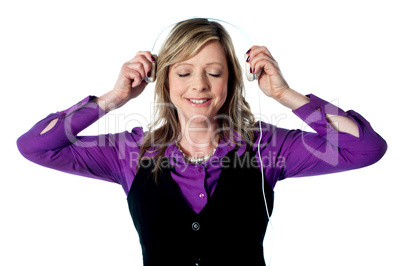 Lady enjoying music through headphones