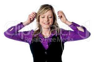 Lady enjoying music through headphones