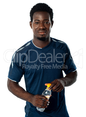 Fit man posing with water bottle