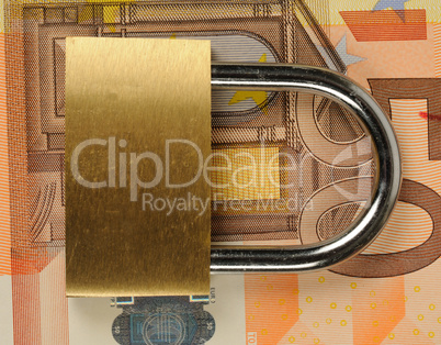 close up of a padlock on Euro banknote