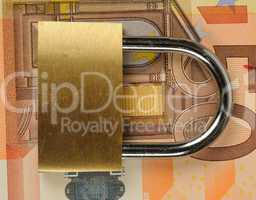 close up of a padlock on Euro banknote