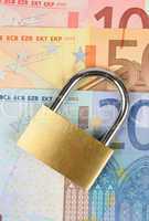 close up of a padlock on Euro banknote