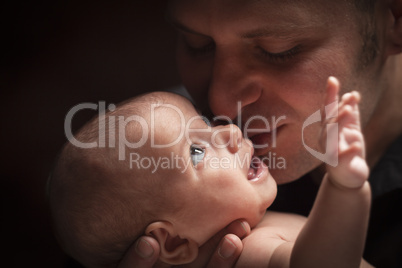 Young Father Holding His Mixed Race Newborn Baby