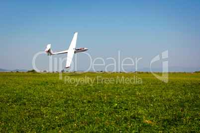 Glider flying on a blue sky