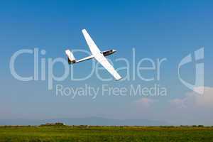 Glider flying on a blue sky