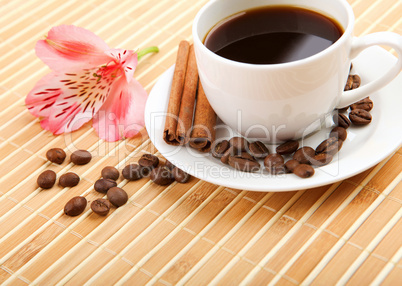 cup of coffee with tubes of cinnamon