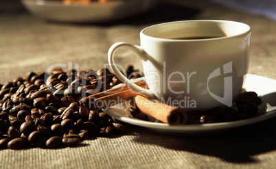 cup of coffee with tubes of cinnamon