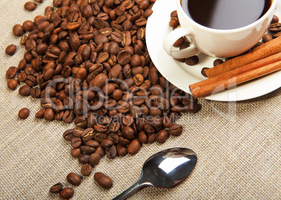 cup of coffee with tubes of cinnamon