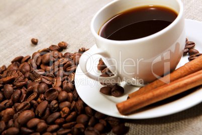 cup of coffee with tubes of cinnamon