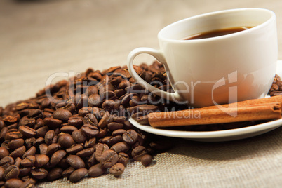 cup of coffee with tubes of cinnamon