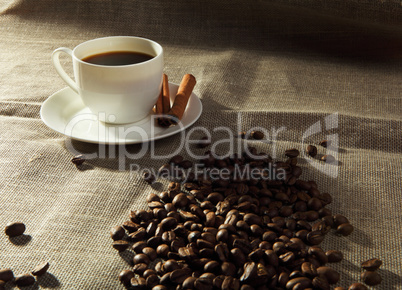 cup of coffee with tubes of cinnamon