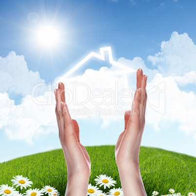 House and human hand against blue sky House and human hand against blue sky