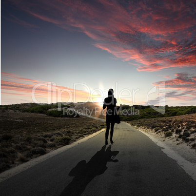 Man walking away at dawn along road