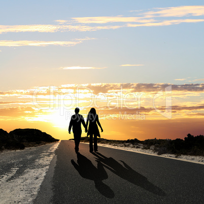 Man walking away at dawn along road