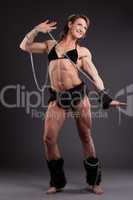 Strong woman body builder posing with chain