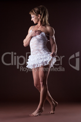 Athletic woman posing in white ballet cloth
