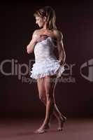 Athletic woman posing in white ballet cloth