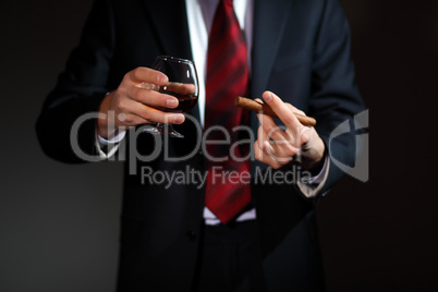 Man with cognac and cigar