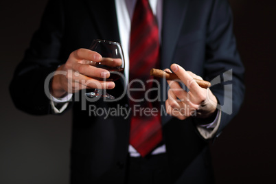 Man with cognac and cigar