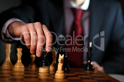 Businessman playing chess